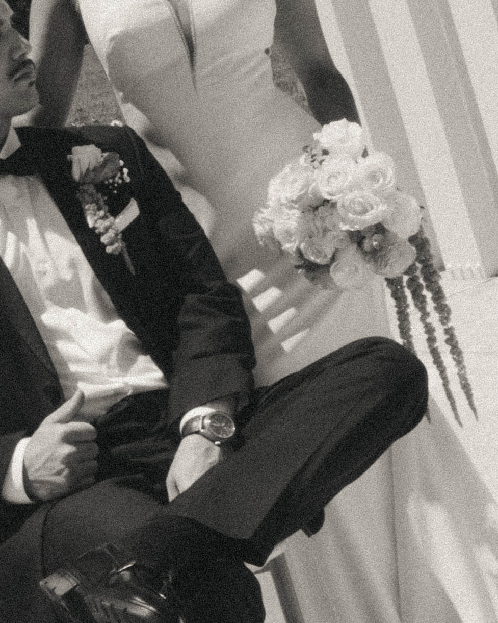 Bride and groom seated together in black and white