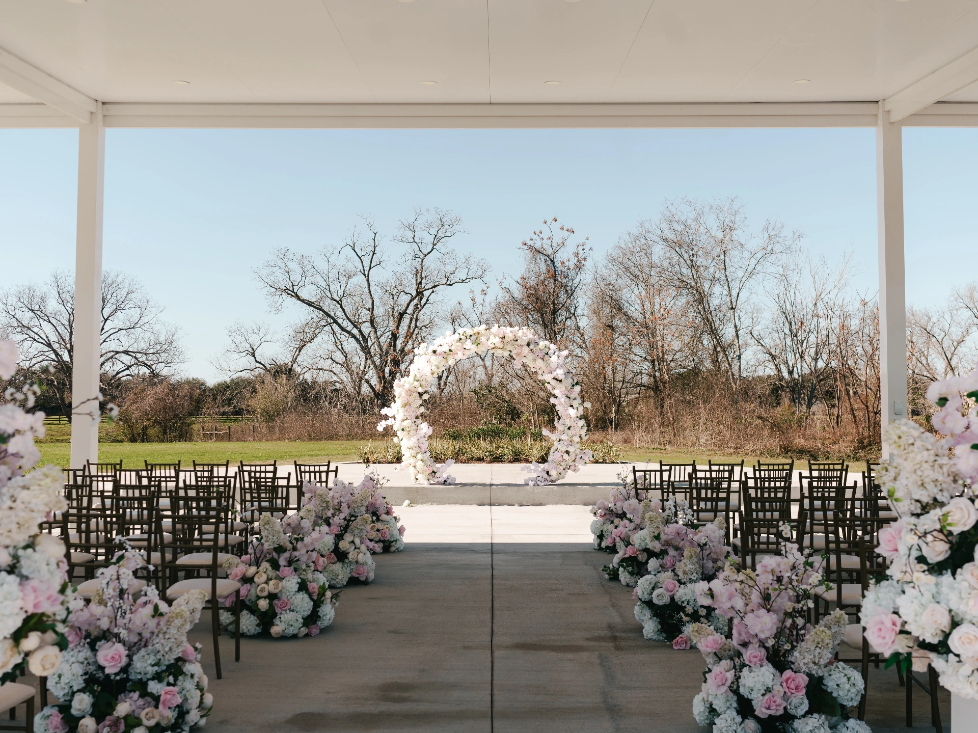Tall floral centerpiece over a candlelit reception table